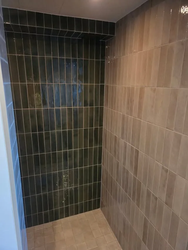 Kakelsättning med grönt kakel i dusch